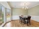 Formal dining room with hardwood floors, bay window, and chandelier at 450 Surveyors Pt, Suwanee, GA 30024