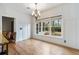 Light-filled dining room featuring hardwood floors, a chandelier, and a large window to the backyard at 450 Surveyors Pt, Suwanee, GA 30024