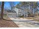 A two-story home with a three car garage and a large driveway at 450 Surveyors Pt, Suwanee, GA 30024