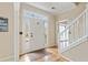 Bright foyer with wood floors, stairway, and white door with sidelights at 450 Surveyors Pt, Suwanee, GA 30024