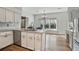 Kitchen area featuring white cabinets, stainless steel appliances, a breakfast bar, and a view to the yard at 450 Surveyors Pt, Suwanee, GA 30024