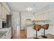 Well-lit kitchen featuring bright white cabinets, modern countertops, and hardwood floors at 450 Surveyors Pt, Suwanee, GA 30024