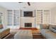 Bright living room featuring a fireplace and built-in bookshelves at 450 Surveyors Pt, Suwanee, GA 30024