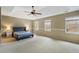 Large main bedroom with neutral paint, tray ceiling, ceiling fan, and natural light at 450 Surveyors Pt, Suwanee, GA 30024