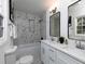 Modern bathroom with a double vanity, marble shower, and white cabinetry at 6030 Danbury Ct, Morrow, GA 30260