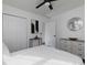 Bright bedroom with white bedding, double doors, and a ceiling fan at 6030 Danbury Ct, Morrow, GA 30260