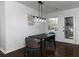 Charming dining room with a black table, grey chairs, and hardwood floors at 6030 Danbury Court, Morrow, GA 30260