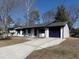 Ranch home with a long driveway, white brick, and navy blue accents at 6030 Danbury Court, Morrow, GA 30260