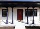 Quaint front porch with red door and white columns at 6030 Danbury Court, Morrow, GA 30260