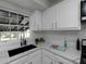 Modern kitchen with white cabinets, quartz countertops, and a farmhouse sink at 6030 Danbury Court, Morrow, GA 30260