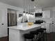 Modern kitchen island with white cabinets and quartz countertop at 6030 Danbury Court, Morrow, GA 30260