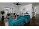 Bright living room with grey sofa, teal armchairs and hardwood floors at 6030 Danbury Ct, Morrow, GA 30260