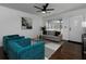 Cozy living room featuring hardwood floors, teal armchairs, and a grey sofa at 6030 Danbury Ct, Morrow, GA 30260