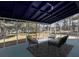 Relaxing screened porch with seating area and blue floor at 6030 Danbury Court, Morrow, GA 30260