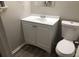 Simple bathroom with white vanity and toilet at 1079 Salisbury Trl, Riverdale, GA 30296