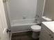 Clean bathroom with a tub/shower combo and white tile at 1079 Salisbury Trl, Riverdale, GA 30296
