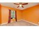 Bright bedroom with orange walls and carpeted floor at 3621 Chattahoochee Ct, Duluth, GA 30096