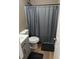 Clean bathroom with shower/tub combo, grey curtain, and wood-look flooring at 2320 Cherokee Valley Dr, Lithonia, GA 30058