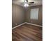 Bright bedroom with wood-look flooring, neutral walls, and ceiling fan at 2320 Cherokee Valley Dr, Lithonia, GA 30058