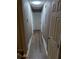 Long hallway with wood-look flooring and neutral walls at 2320 Cherokee Valley Dr, Lithonia, GA 30058