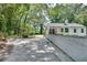 Long driveway leading to a charming white brick house with lush landscaping at 265 Whitaker Nw Cir, Atlanta, GA 30314