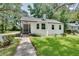 Charming white brick ranch house with a spacious front yard and mature trees at 265 Whitaker Nw Cir, Atlanta, GA 30314