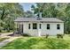 Charming white brick ranch house with a spacious front yard and mature trees at 265 Whitaker Nw Cir, Atlanta, GA 30314