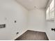 Simple laundry room with dark hardwood floors and white walls at 265 Whitaker Nw Cir, Atlanta, GA 30314