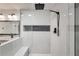 Walk-in shower with marble tile and black fixtures at 265 Whitaker Nw Cir, Atlanta, GA 30314