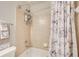 Bright bathroom featuring a tiled shower and tub combination with marble-themed shower curtain at 4694 Wehunt Commons Se Dr # 25, Smyrna, GA 30082