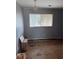 Small bedroom with gray walls and wood-look flooring at 7420 Nulan Way, Riverdale, GA 30274