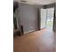 Living area with wood-look flooring and gray walls at 7420 Nulan Way, Riverdale, GA 30274