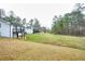 Spacious backyard view showcasing the home, back deck, and surrounding trees, providing a serene and private outdoor experience at 218 Ward Rd, Ellenwood, GA 30294
