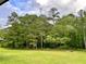 Expansive backyard space boasting a well-maintained lawn and mature trees for added privacy at 218 Ward Rd, Ellenwood, GA 30294