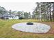 Large backyard featuring a fire pit area, lush greenery, and plenty of room for outdoor activities and entertaining guests at 218 Ward Rd, Ellenwood, GA 30294