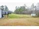 Expansive backyard featuring lush green grass, mature trees, and a walkout basement; perfect for outdoor activities and enjoyment at 218 Ward Rd, Ellenwood, GA 30294