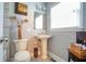 Bathroom featuring a pedestal sink, toilet, and decorative elements at 218 Ward Rd, Ellenwood, GA 30294