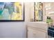 Bathroom featuring modern sink, vanity, mirror and colorful abstract art at 218 Ward Rd, Ellenwood, GA 30294