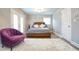 Bedroom featuring a decorative chair, soft carpet, and lots of natural light at 218 Ward Rd, Ellenwood, GA 30294