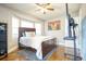 Comfortable bedroom with a large bed, bay windows providing natural light, and hardwood floors at 218 Ward Rd, Ellenwood, GA 30294
