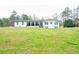 Ranch-style home with a white exterior, a covered front porch, and a spacious front yard with mature trees at 218 Ward Rd, Ellenwood, GA 30294