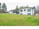 Charming white brick home with black accents, front porch, and spacious lawn at 218 Ward Rd, Ellenwood, GA 30294