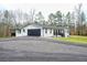 Charming white brick home with black accents, two-car garage, and spacious lawn at 218 Ward Rd, Ellenwood, GA 30294