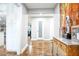 Bright hallway featuring hardwood floors, white cabinets, and decorative elements, adding a touch of elegance to the home's entrance at 218 Ward Rd, Ellenwood, GA 30294
