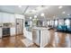 Bright kitchen features white cabinetry, stainless appliances, granite counters and views of the living and dining areas at 218 Ward Rd, Ellenwood, GA 30294