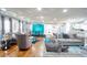 Open-concept living room with hardwood floors, large windows, and stylish furnishings and decor throughout at 218 Ward Rd, Ellenwood, GA 30294