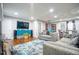 Well-lit living room with hardwood floors, stylish rug, and a modern entertainment center at 218 Ward Rd, Ellenwood, GA 30294