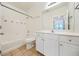 Clean bathroom with white vanity, tub, and tile flooring at 2211 Westchester Rdg, Atlanta, GA 30329