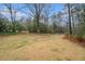 Spacious backyard with mature trees and a manicured lawn at 275 Pineland Nw Rd, Atlanta, GA 30342