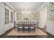 Formal dining room with floral wallpaper, a large window, and a view to the living room at 275 Pineland Nw Rd, Atlanta, GA 30342